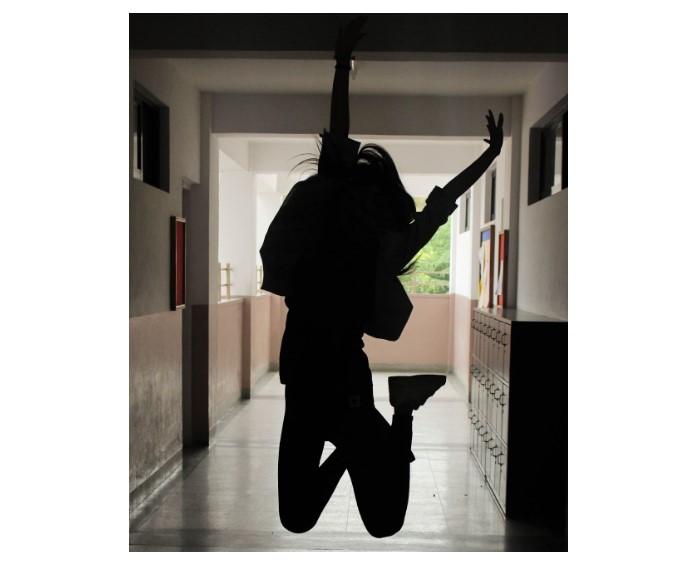 Person Jumping in School Hallway